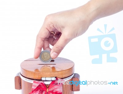 Putting Coin To Save Money Stock Photo