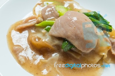 Rad Na, Famous Thai Chinese Style Wide Rice Noodle Dish With Tasty Tender Pork With Thick Gravy Sauce. Close Up Stock Photo