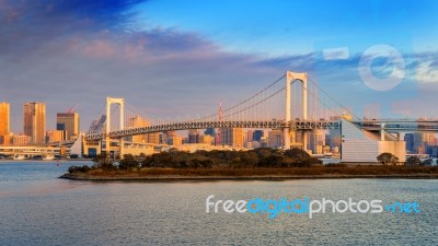 Rainbow Bridge And Tokyo Cityscape At Sunrise, Japan Stock Photo