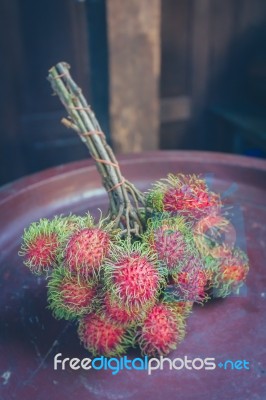 Rambutan On Wood Stock Photo