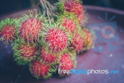 Rambutan On Wood Stock Photo