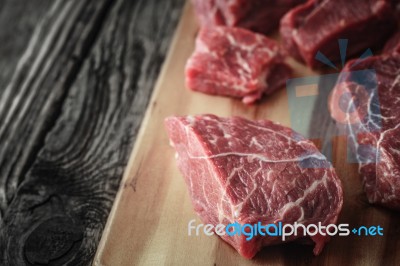 Raw Angus Beef Slices On The Wooden Board  Horizontal Stock Photo