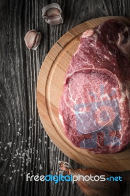 Raw Angus Beef  With Seasoning On The Wooden Table Vertical Stock Photo