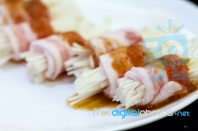 Raw Bacon Wrapped With Needle Mushroom Stock Photo