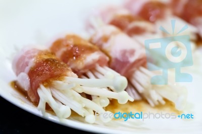 Raw Bacon Wrapped With Needle Mushroom Stock Photo