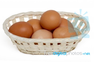 Raw Chicken Eggs Inside A Wicker Basket Stock Photo