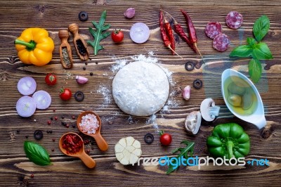 Raw Dough With Ingredients For Homemade Pizza On Shabby Wooden B… Stock Photo