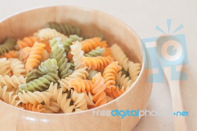 Raw Fusilli Pasta In Wooden Bowl Stock Photo