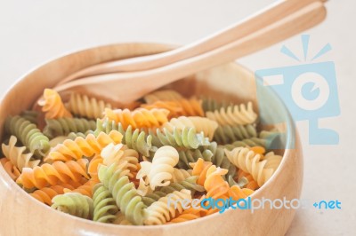 Raw Fusilli Pasta In Wooden Bowl Stock Photo