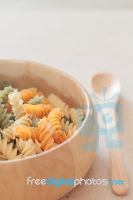 Raw Fusilli Pasta On Wooden Tray Stock Photo