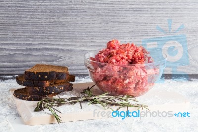 Raw Minced Meat With Bread And Rosemary Stock Photo