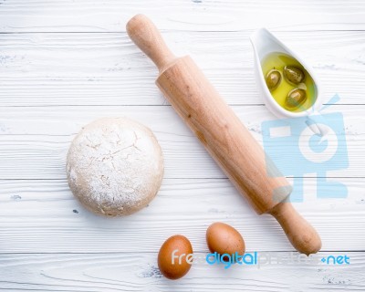 Raw Pizza Dough And Rolling Pin On Wooden Background Stock Photo