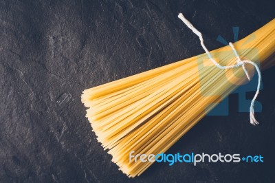 Raw Spaghetti On The Black Stone Background Stock Photo