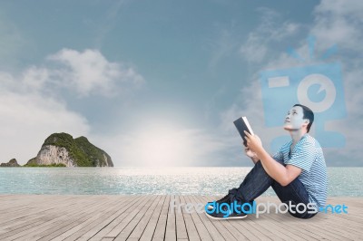 Reading On The Beach Stock Photo