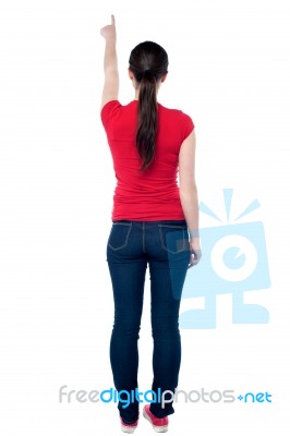 Rear View Of A Young Girl Pointing At Something Stock Photo