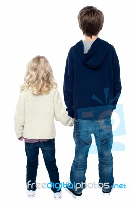 Rear View Of Two Little Kids. Boy Holding His Sister Stock Photo