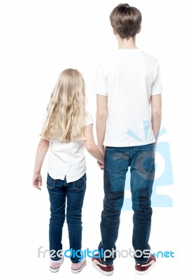 Rear View Of Young Brother Holding His Sister Stock Photo