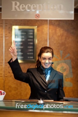 Receptionist showing Pointing Up Stock Photo