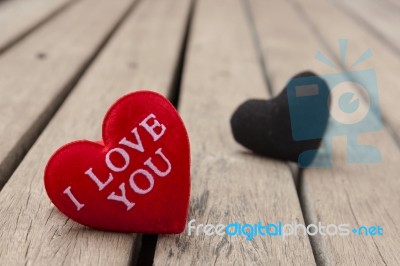 Red And Black Heart On Wood Floor Stock Photo