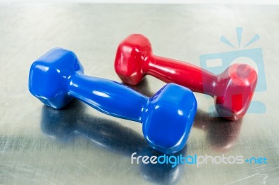 Red And Blue Dumbbell Weight For Fitness Stock Photo