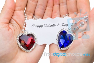 Red And Blue Jewelry Heart With Valentine Card On Hands Stock Photo