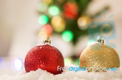 Red And Gold Chrismas Ball On Snow With Chrismas Tree Background… Stock Photo