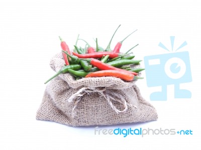 Red And Gren Chilli And Brown Bag With White Background  Stock Photo