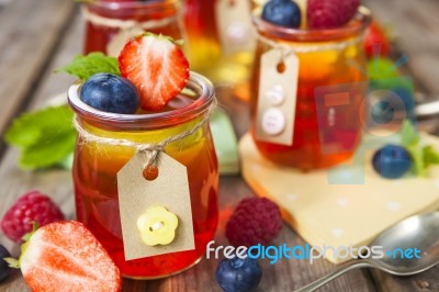 Red And Yellow Jelly Served With Fruit Stock Photo