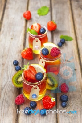 Red And Yellow Jelly Served With Fruit Stock Photo