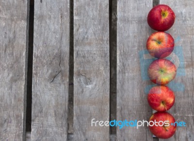 Red Apples On Rustic Wooden Background Stock Photo