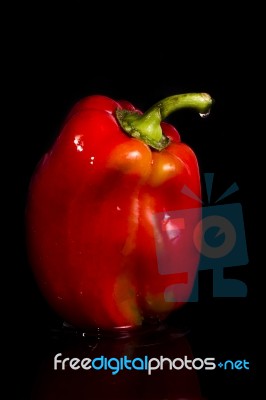 Red Bell Pepper On A Black Background Stock Photo