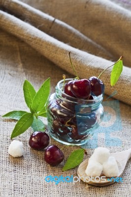 Red Cherries In Glass Jar Stock Photo