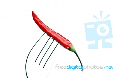 Red Chili Pepper On A Fork Stock Photo