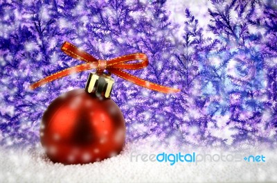 Red Christmas Ball On Snow With Christmas Tree Stock Photo