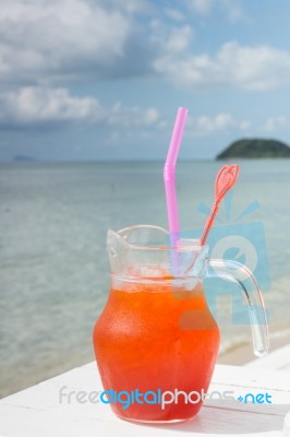 Red Cocktail On White Table Set Over Ocean Stock Photo