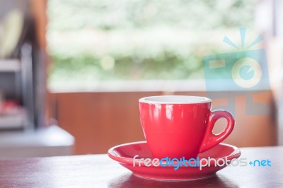 Red Coffee Cup On Wooden Table Stock Photo