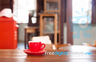 Red Coffee Cup On Wooden Table Stock Photo