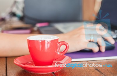 Red Coffee Cup On Work Station Stock Photo