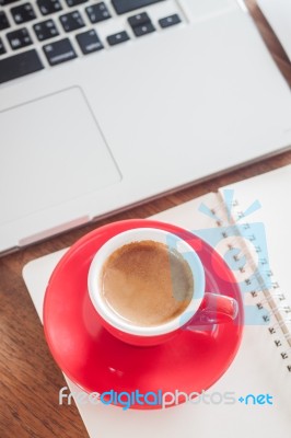 Red Coffee Cup With Notepad And Laptop Stock Photo