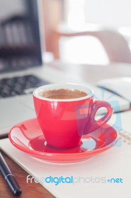 Red Coffee Cup With Notepad And Laptop Stock Photo