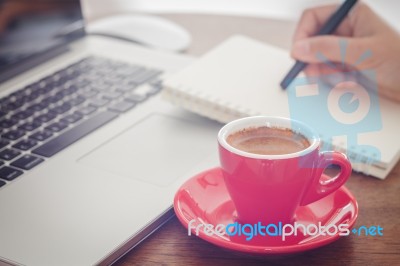 Red Coffee Cup With Notepad And Laptop Stock Photo