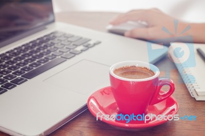 Red Coffee Cup With Notepad And Laptop Stock Photo