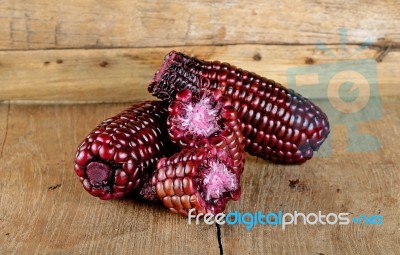 Red Corn On The Wooden Background Stock Photo