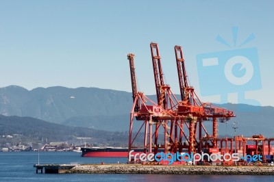 Red Cranes In Vancouver Harbour Stock Photo