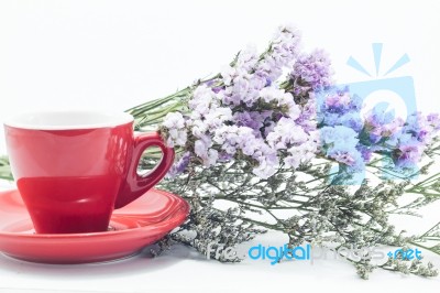 Red Cup Of Cofee And Static Flower Stock Photo