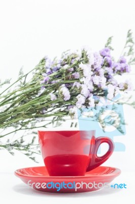 Red Cup Of Cofee And Static Flower Stock Photo