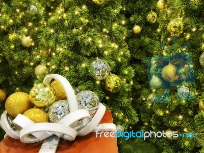 Red Gift Box With White Ribbon And Christmas Tree Stock Photo