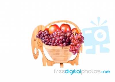 Red Grapes And Apples In Wooden Basket As Elephants Isolated On Stock Photo