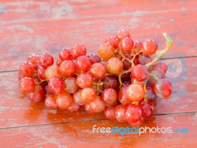 Red Grapes On The Wooden Table  .  Stock Photo