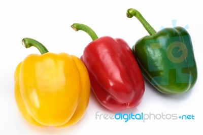 Red Green And Yellow Sweet Peppers On White Background Stock Photo